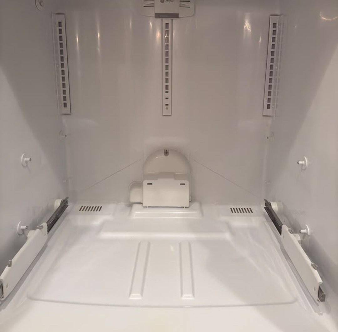 The same fridge after a Metro Vancouver Cleaning deep clean — spotless white interior